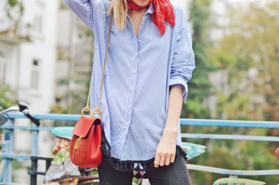 red handbag, red leather, red bandanna, blue blouse, jeans