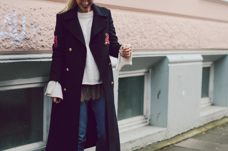 white pullover, winter coat, golden buttons, jeans