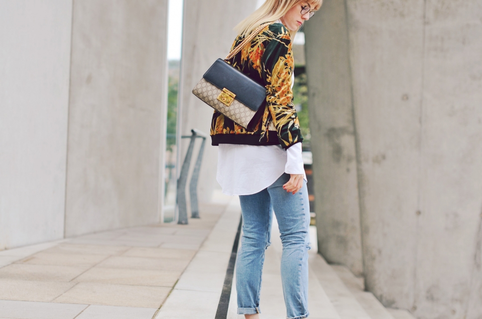 gucci handbag, flower pattern, blue jeans, white blouse